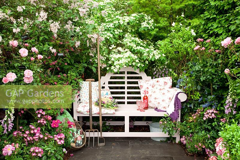Seating area with fragrant plants, Rosa, Cornus kousa, Syringa 