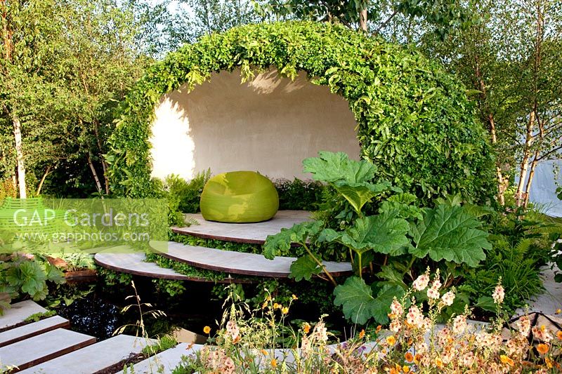Modern garden with pond and seating area 