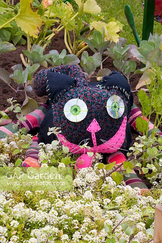 Cat made by children from recycled materials with discs as eyes 