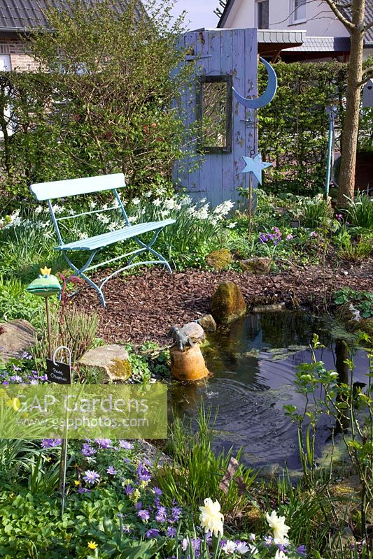 Seating area by the pond, daffodils and anemones, Narcissus triandrus Thalia, Anemone blanda 