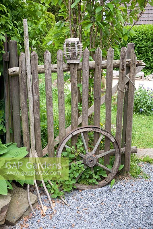 Stillife wooden fence with wagon wheel and pitchfork 