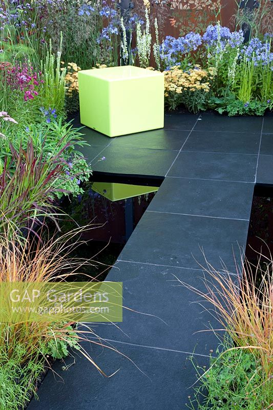 Modern terrace with pond, Campanula Prichards Variety, Achillea Terracotta, Imperata cylindrica Red Baron 