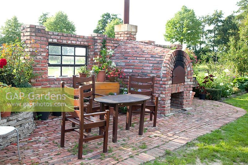 Seating area on wall with wood-fired oven 