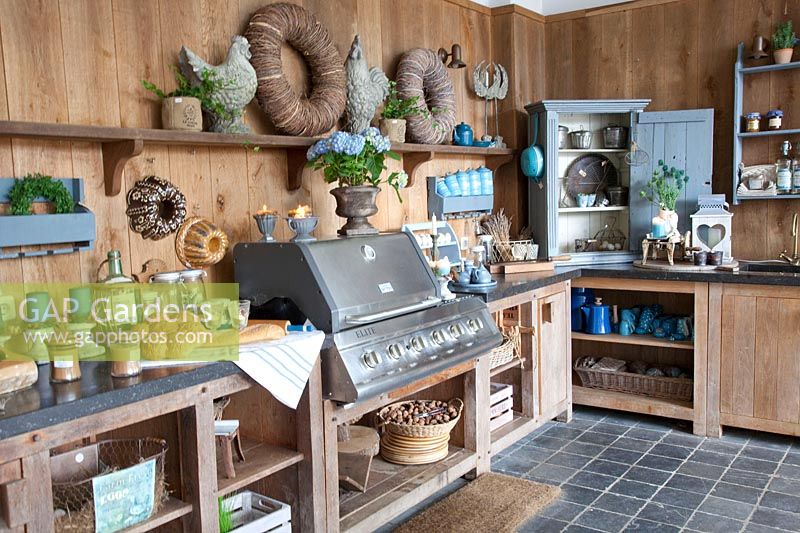 Stylish outdoor kitchen on covered terrace 