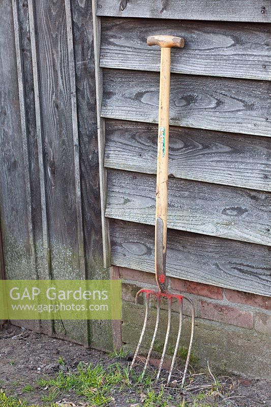 Old pitchfork on the garden shed 