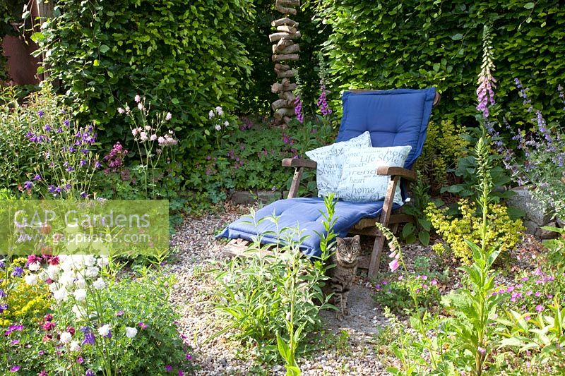 Seating in the country garden with cat 