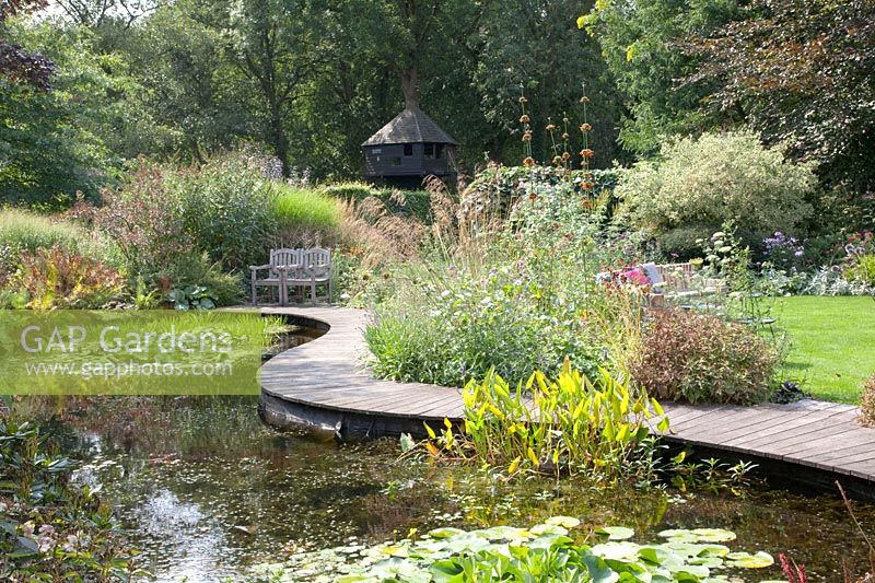 Pond with curved wooden walkway 