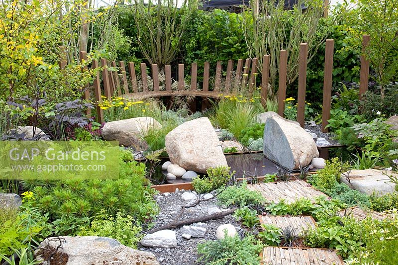 Modern garden with bench and rocks 