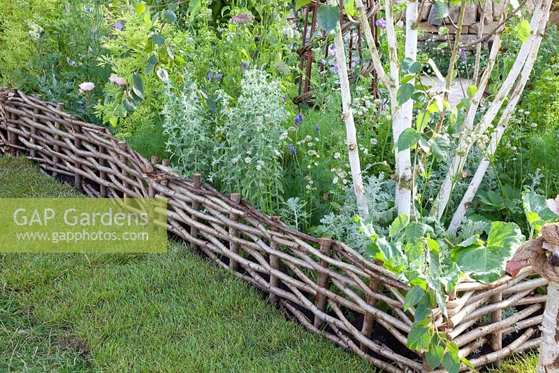 Bed edging made of woven willow branches 