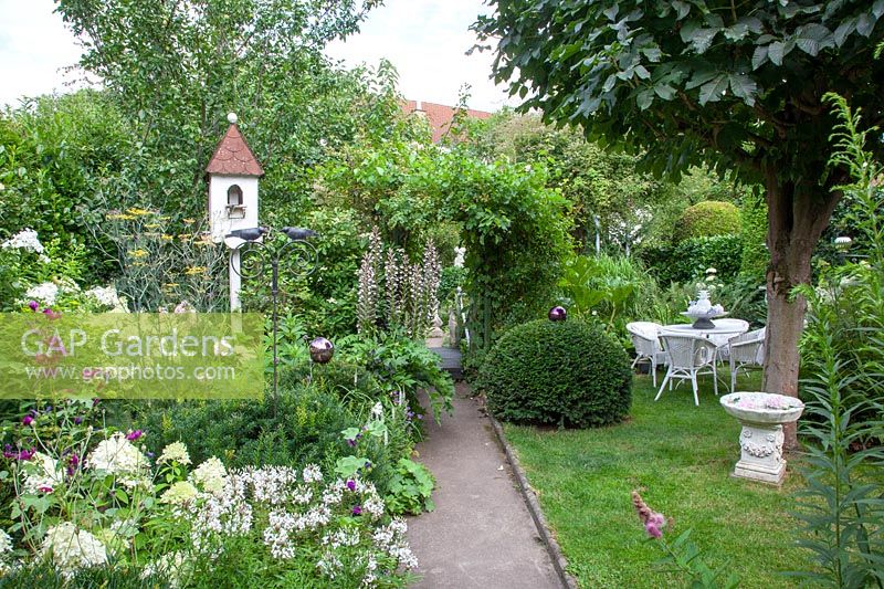 Romantic garden with chestnut tree, seating area and dovecote 
