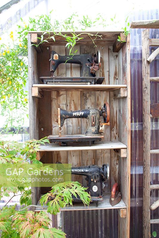 Shelf with old sewing machines 