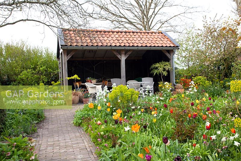 Country garden with arbor in spring 