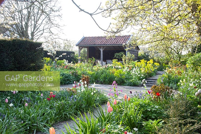 Country garden with arbor in spring 
