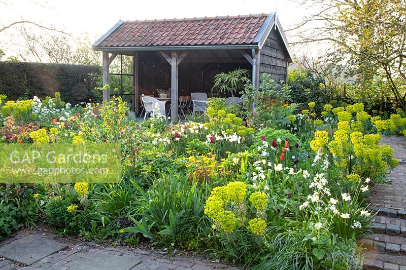 Country garden with arbor in spring 