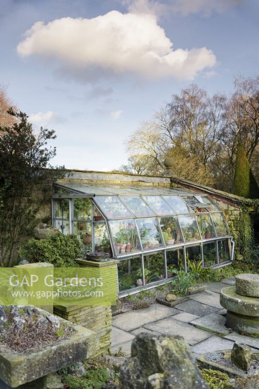 Sunken glasshouse on one side of the Paved Garden at York Gate in February