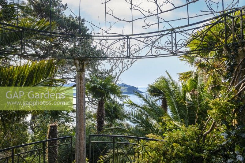 Classical style ornate metal temple with a view towards the St Mawes Harbour, hardy palms surround in this semi tropical garden