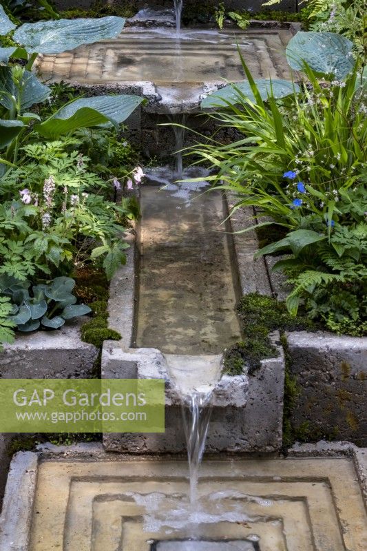 A concrete rill connecting one square pool to another on The Ecotherapy Garden: Designed by Tom Bannister