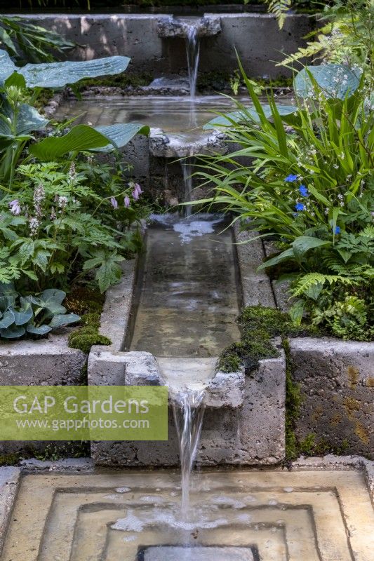 Water running down a series of chutes, a rill into a square pool on The Ecotherapy Garden: Designed by Tom Bannister