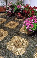Patio with pebble mosaics and pots with Begonias in Cordoba patio festival in Spain