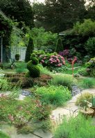 Garden with mixed planting and topiary at Long Island USa