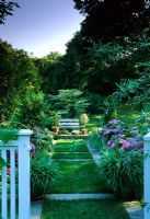 Garden with grass path with stone insets creating pattern at Long Island USa