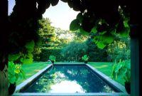 Formal rectangular swimming pool in lawn, private garden on Long Island in USA