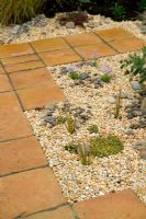Dry garden with terracotta paving and gracel mulch at Capel Manor Show Gardens