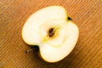 Half an apple on chopping board