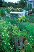 Viev over picket fence to garden table and chairs at Wood Farm in Suffolk 