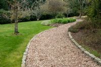 Granite blocks as path edging on wood chip path at Pine Lodge Gardens Near St. Austell.