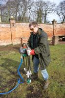 Man with aeration machine used to repair compacted ground