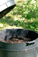 Wormery (Worm Tower or Can-o-worms) used to turn garden and kitchen waste into garden compost by the action of worms. Bottom level tray - fully worked compost ready to harvest. Once harvested this tray becomes the new top level tray.