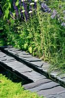 Quarried slate rill with chamaemelum nobile treneague and Salvia selinum - Repetition and Difference garden Hampton Court FS 



