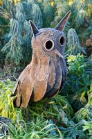 Rusty metal owl statue in frost