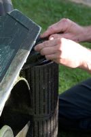 Maintaining and fixing a belt on the under side of a Hayter lawn mower in autumn