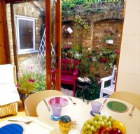 Eating area in small walled back garden   