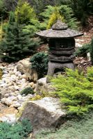 Japanese Lantern placed on rocks in Japanese garden - White Knights Buckinghamshire