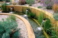 Gravel garden with water rill, rendered concrete walls and three spouts