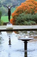 The Italian garden at Borde Hill with formal rectangular pond and statue.