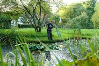 Boy fishing for pond life with net