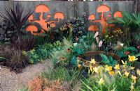 Garden fence with stencilled cut outs painted in bright colours - Hampton Court 2007