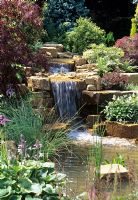 Water garden with sandstone rock waterfall