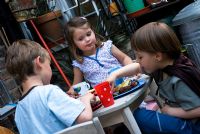 Children eating outside at a barbecue