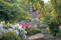 Oriental garden with stone lanterns, temple and Rhododendrons 