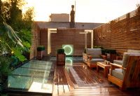 Contemporary roof garden with decking, seating, fences, containers of Buxus and skylight - Wilton Place, London