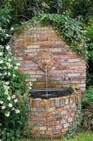 A running water feature with an ornamental Lion's head