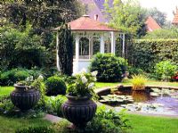Small garden with round pond and pavillon