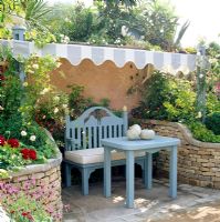 Bench and table shaded by striped canopy - DGAA Homelife Garden, Chelsea 1997