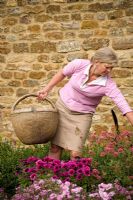 Woman dead-heading containers 