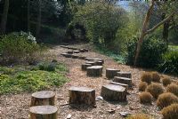 Stepping 'stones' made from tree trunks  leading to Willow arbor 